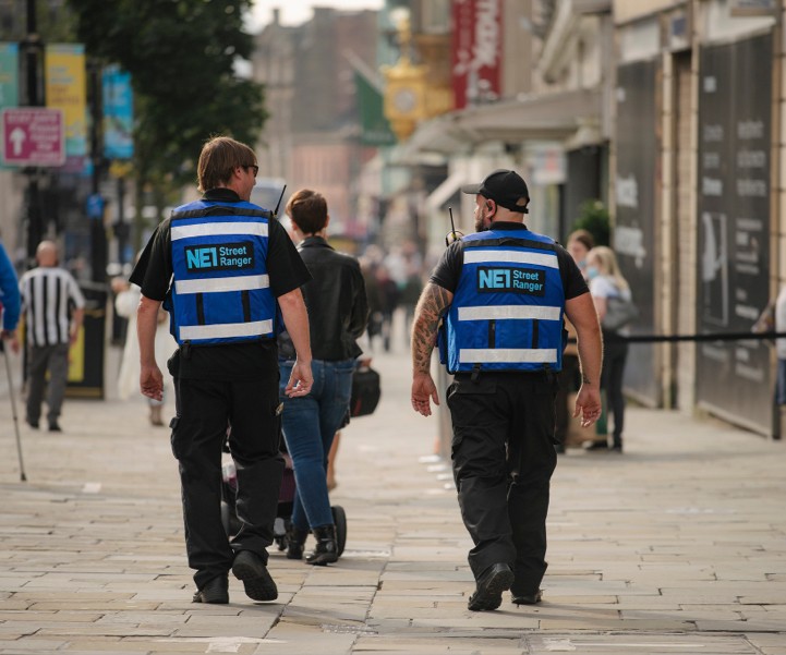 Two NE1 street rangers walking through Newcastle
